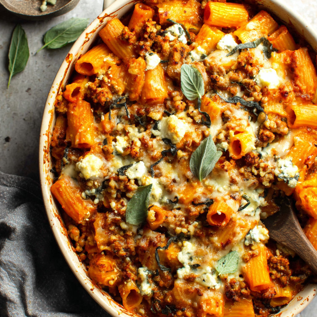 A bowl of pasta with meat and cheese.