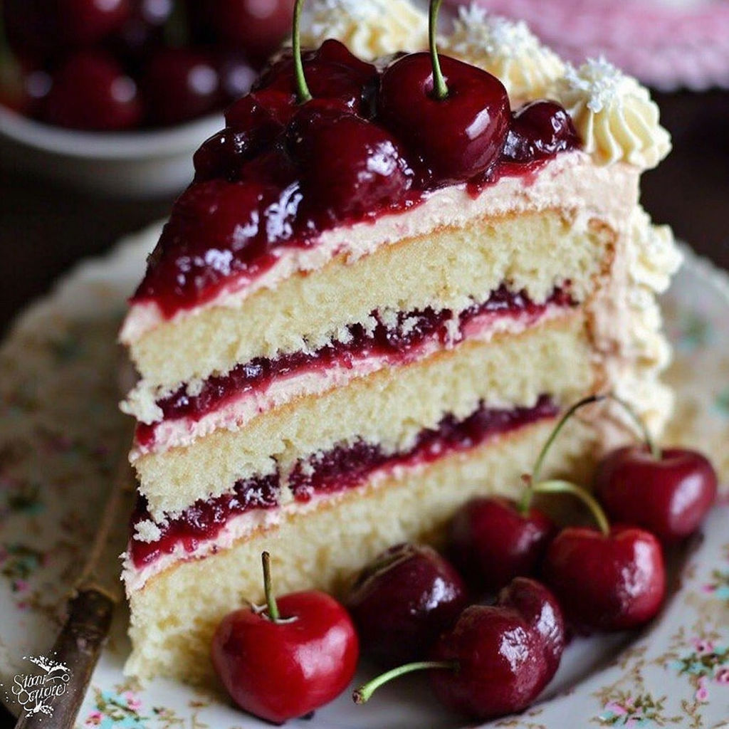 A slice of cake with cherries on top.