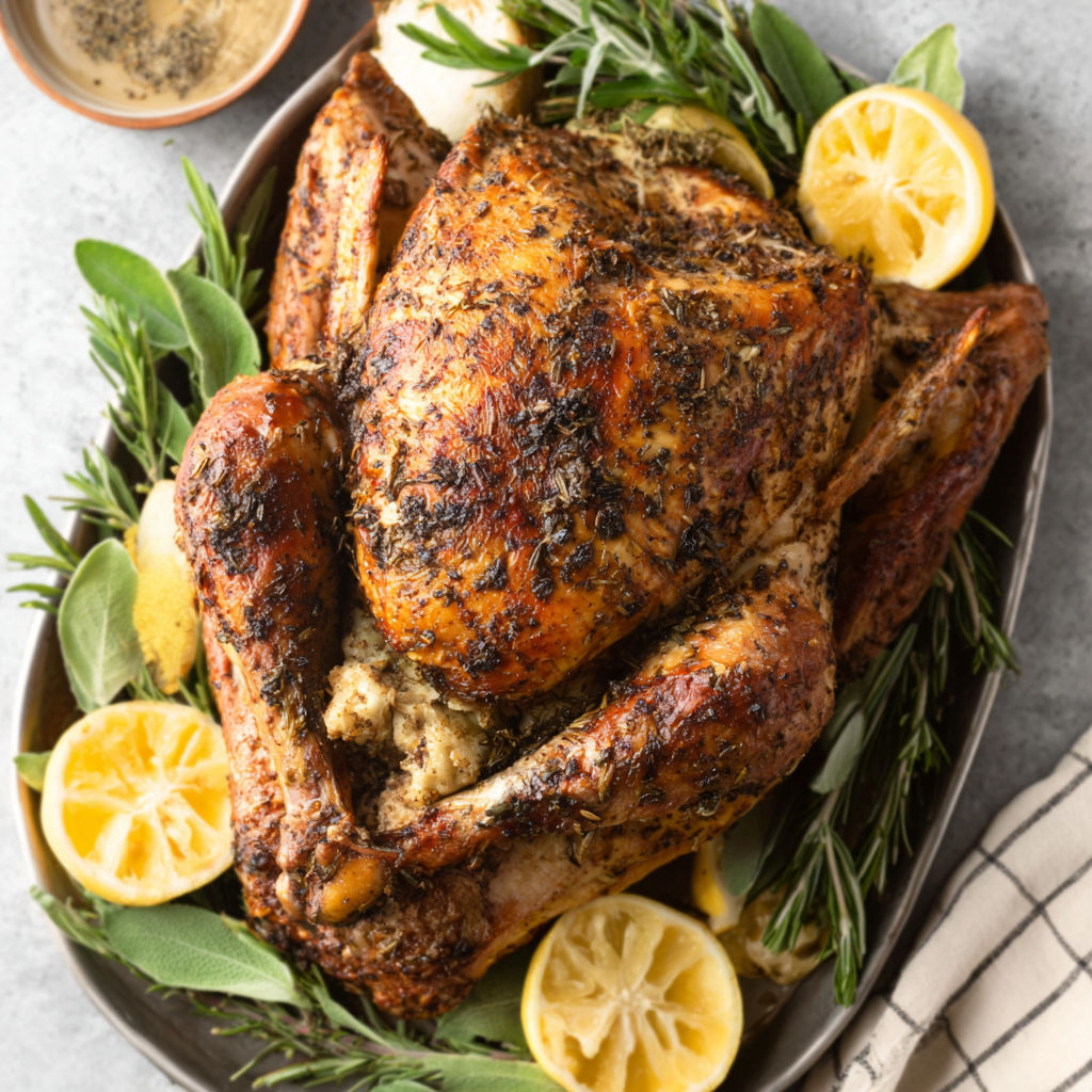 A roasted chicken with lemon and herbs.