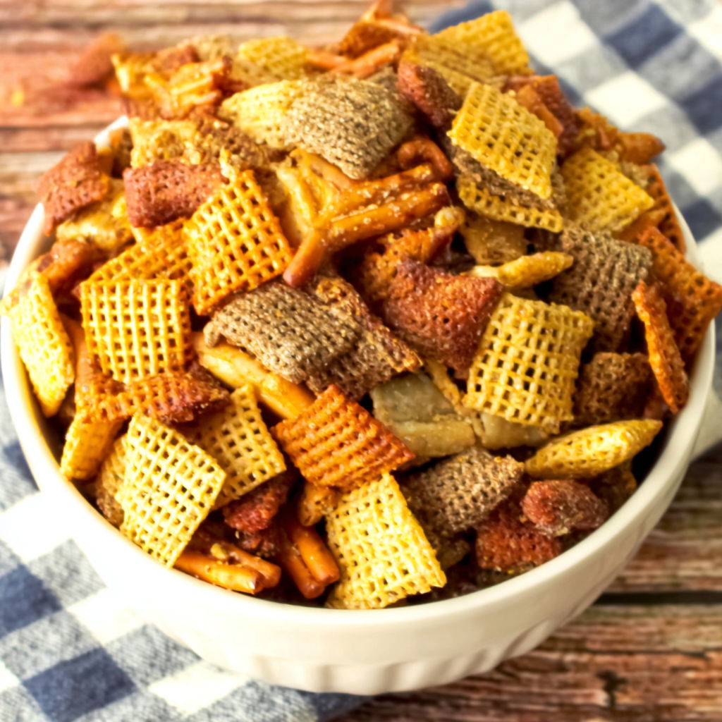A bowl of chips with a blue and white checkered cloth.