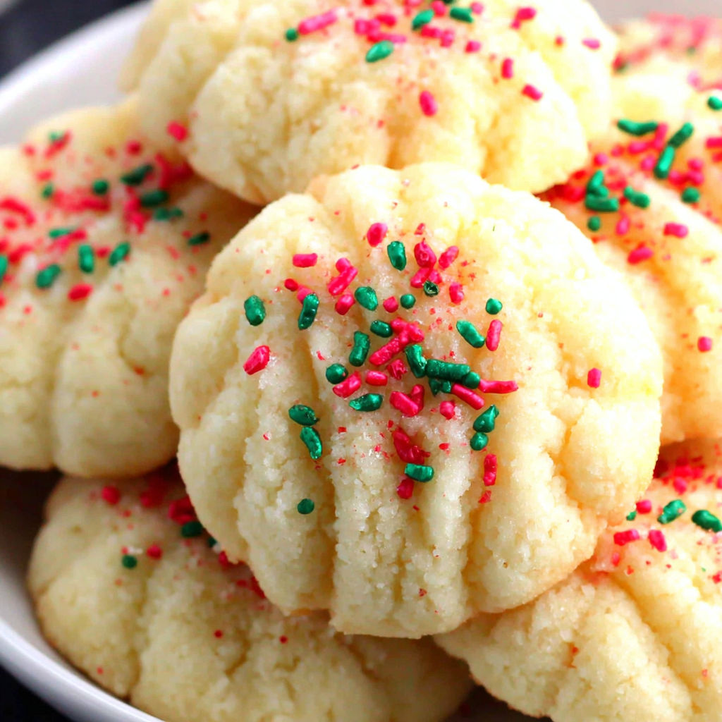 A bowl of cookies with sprinkles.
