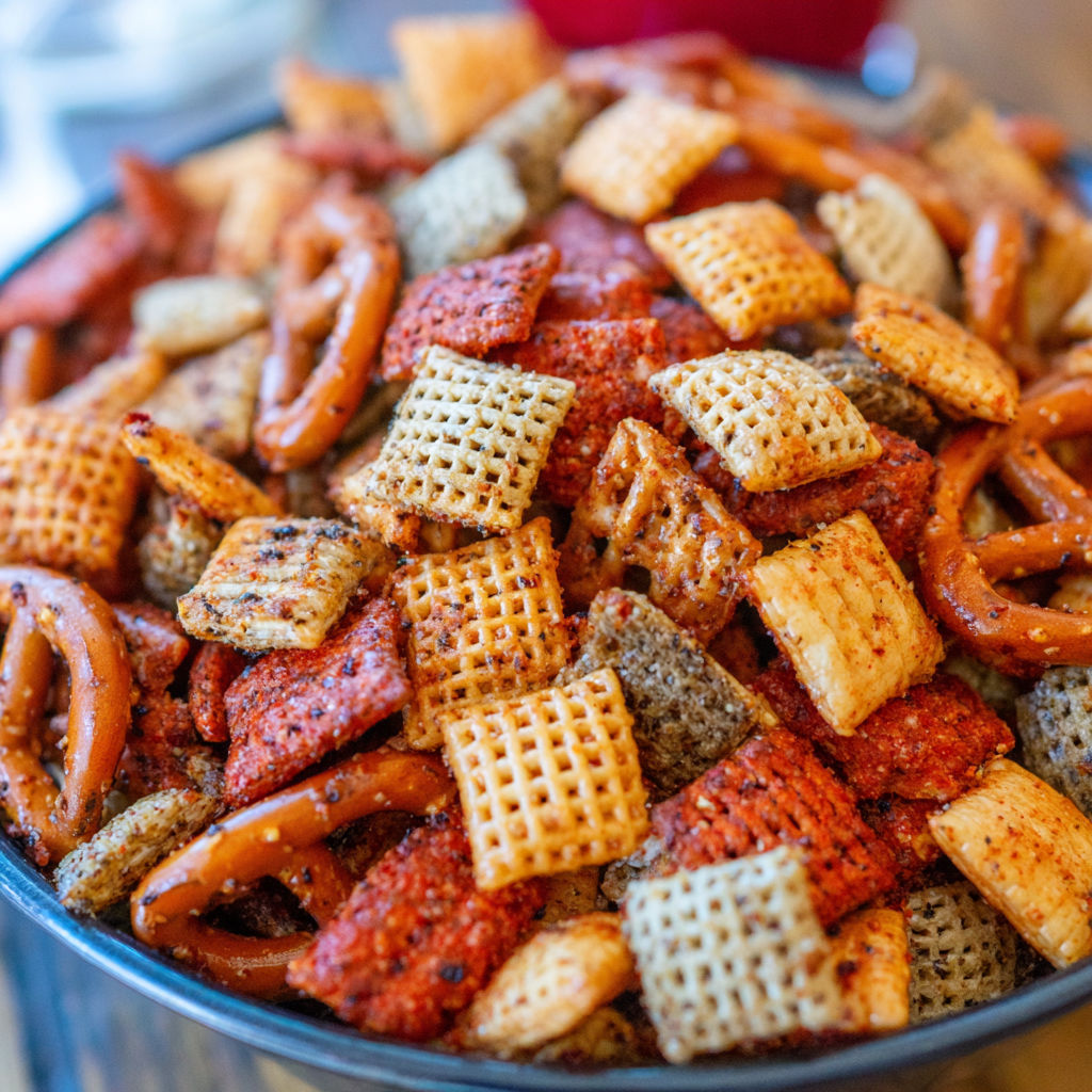 A bowl of chips and pretzels.