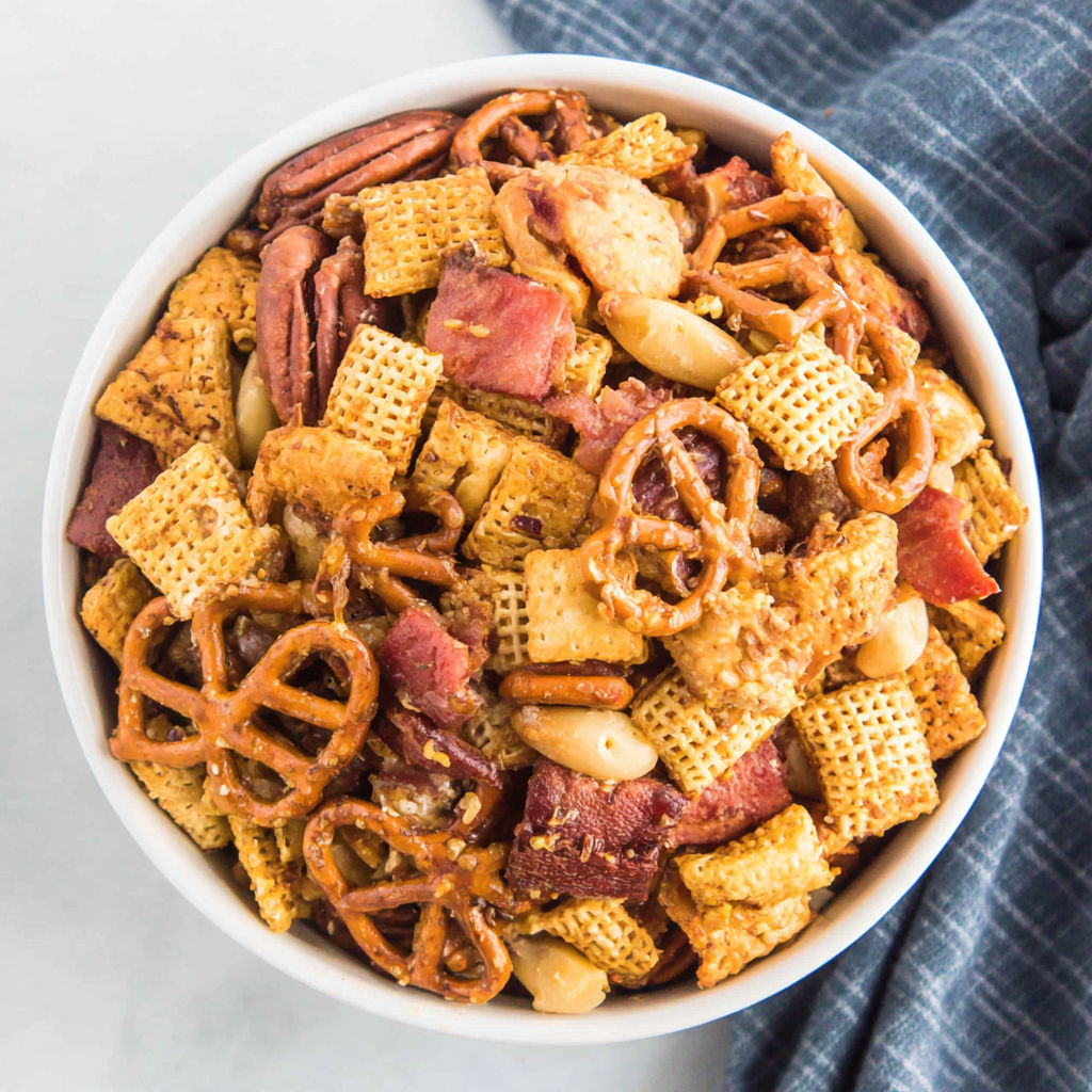 A bowl of chips and pretzels.