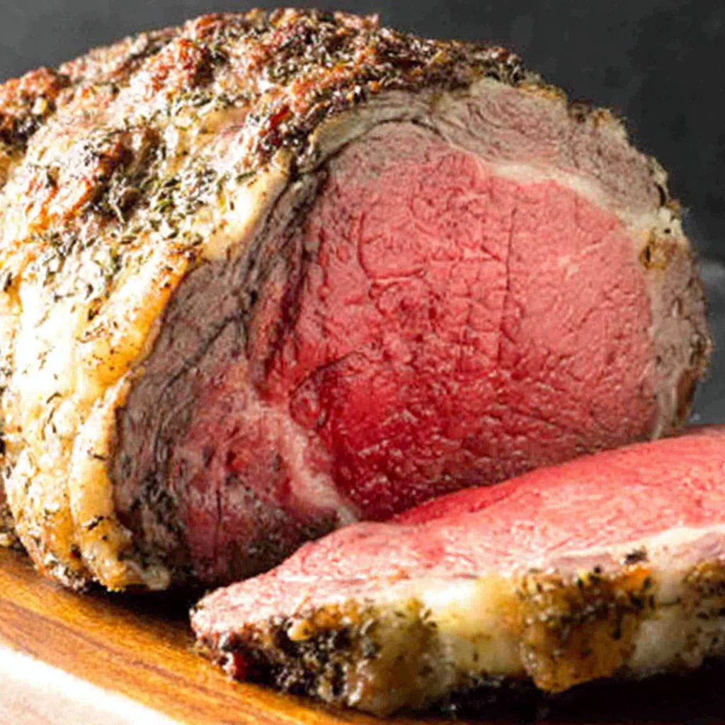 A large piece of meat with seasoning on it.