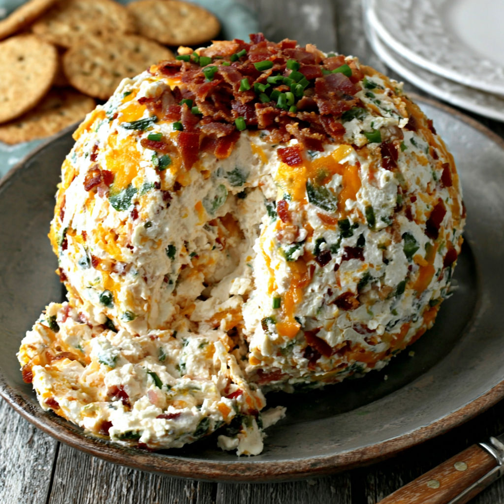 A plate of food with a bacon and cheese casserole.