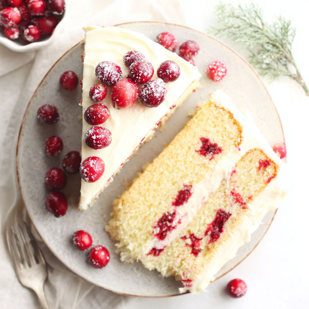A slice of cake with berries on top.
