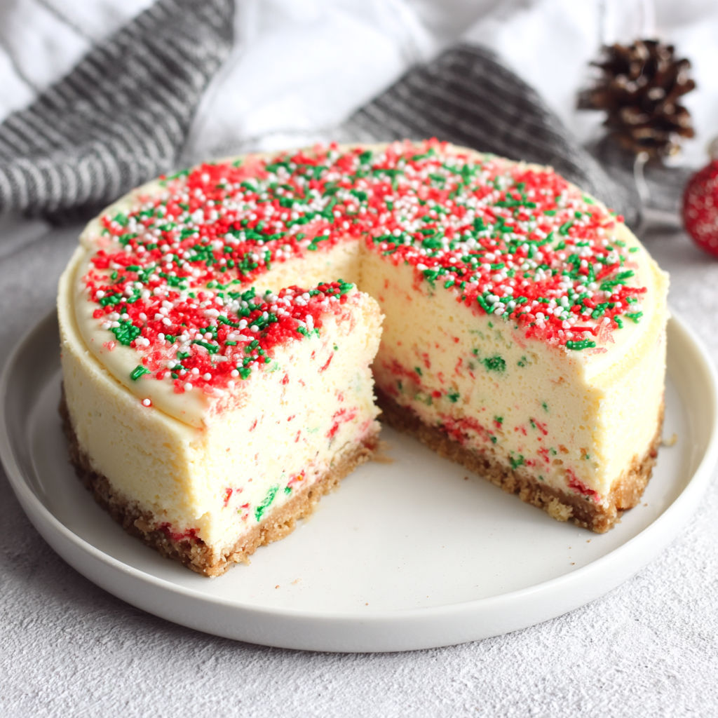A slice of cake with red and green sprinkles.