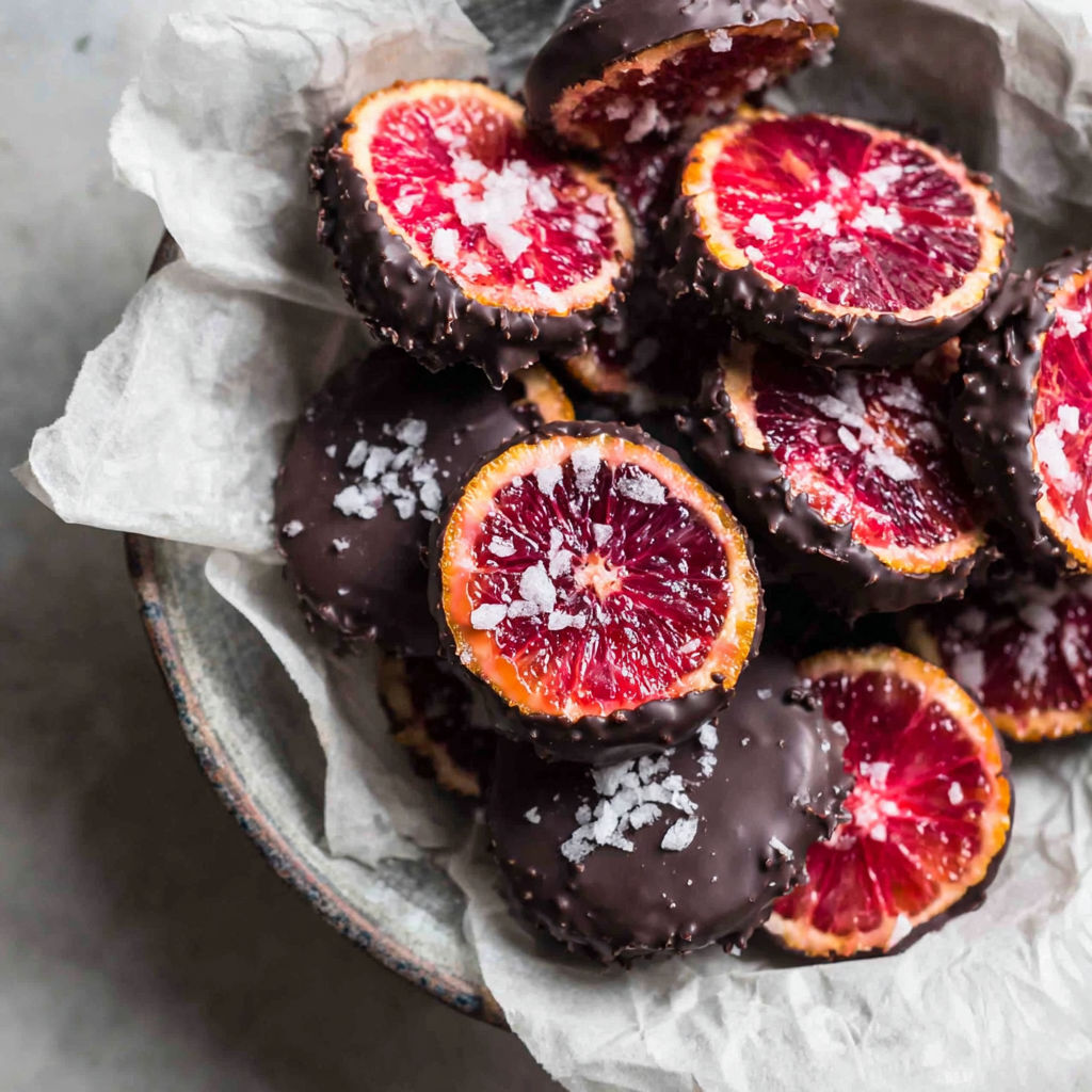 A bowl of chocolate covered orange slices.