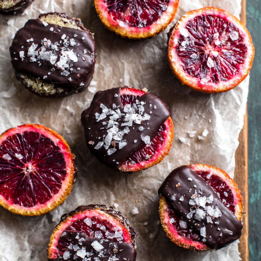 A plate of chocolate covered blood oranges.