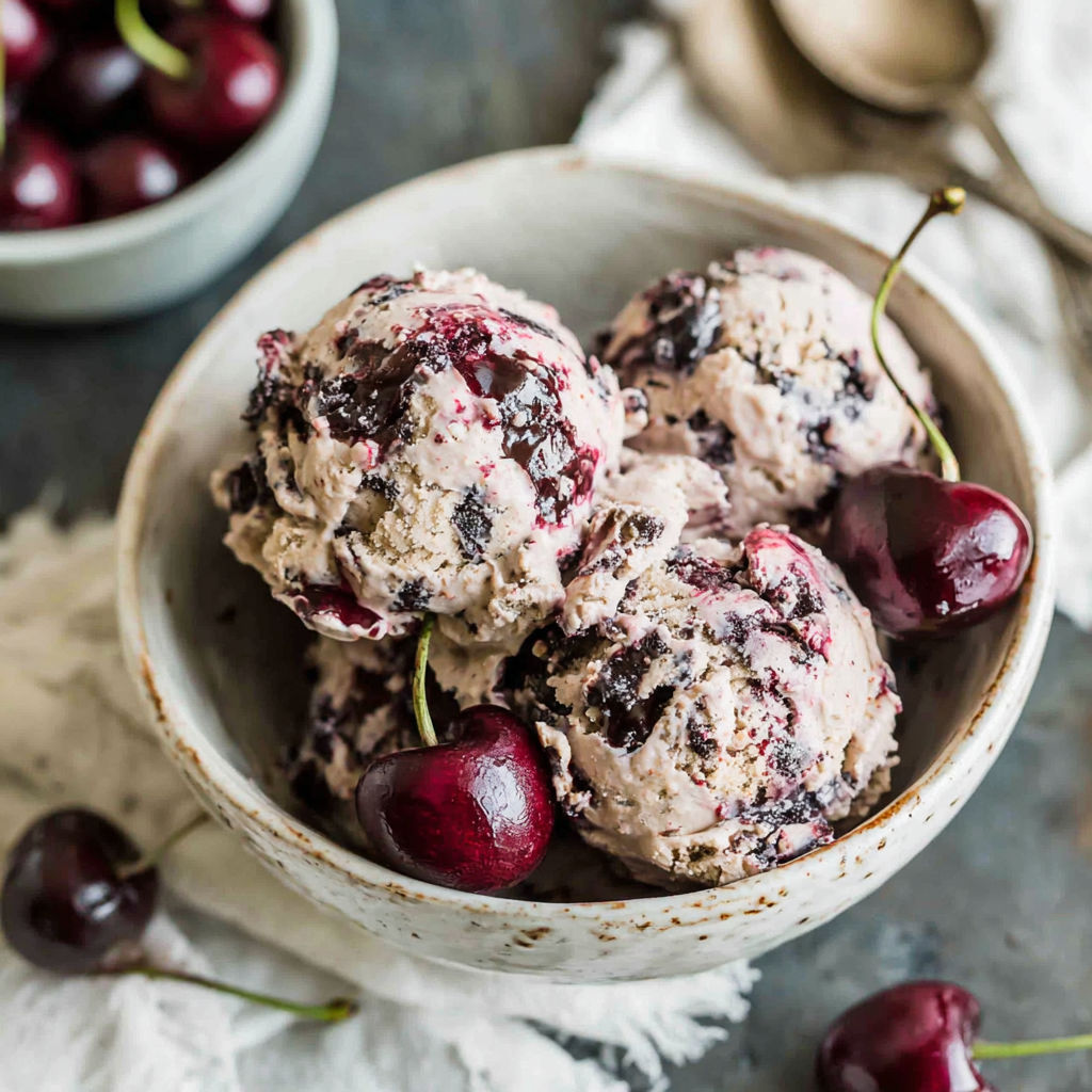 A bowl of cherries and ice cream.