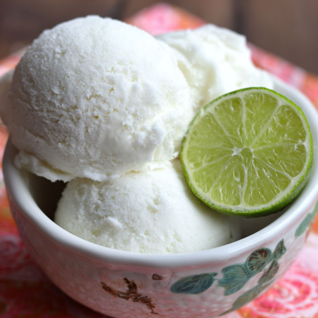 A bowl of ice cream with a lime wedge on top.