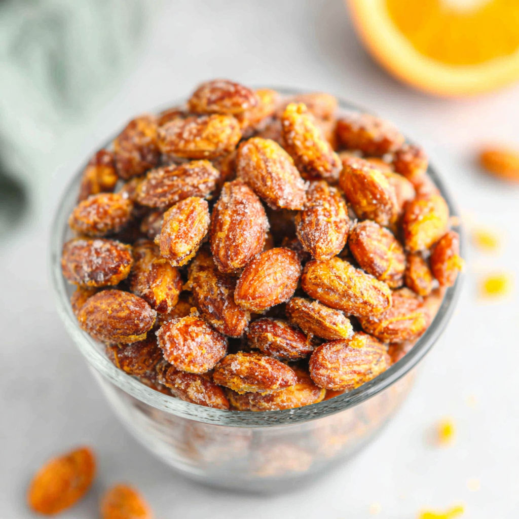 A glass bowl filled with almonds.