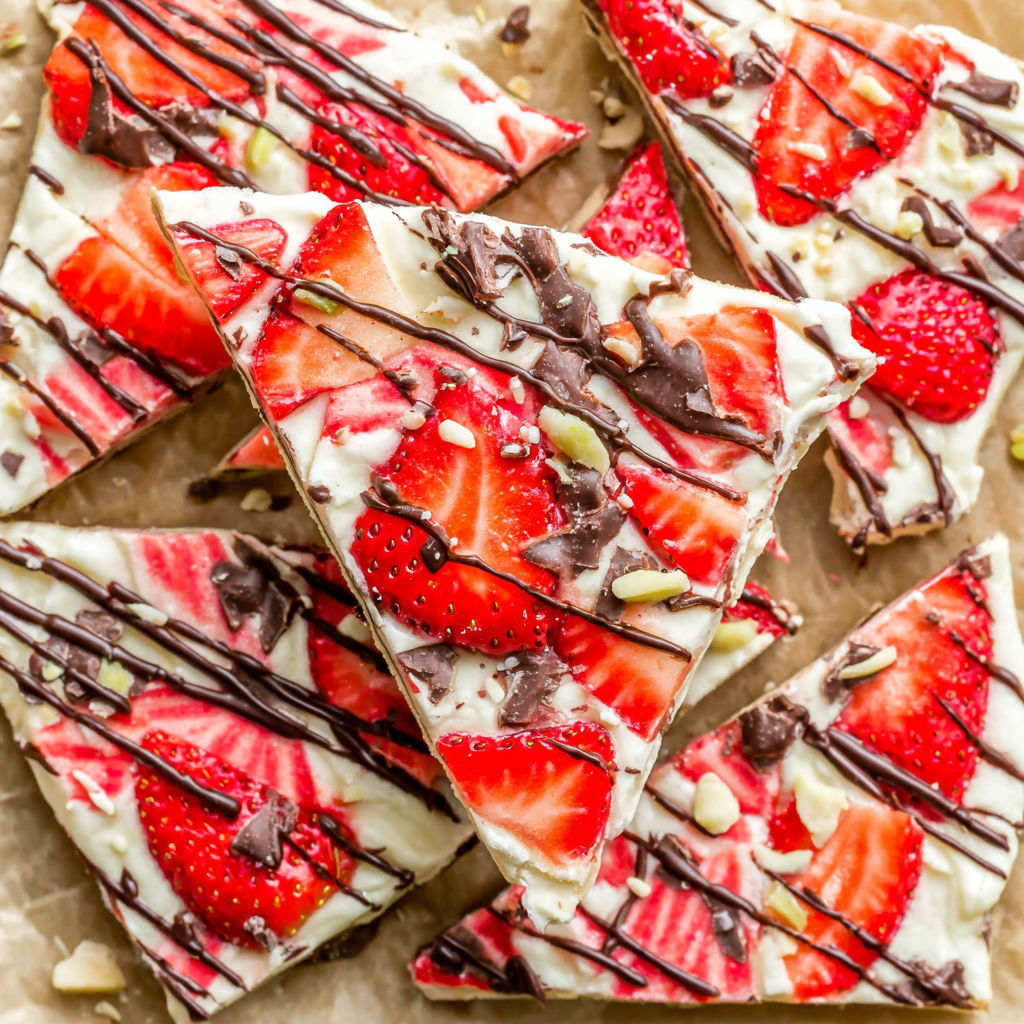 A close up of a strawberry dessert with chocolate drizzle.