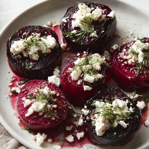 A plate of food with red beets and feta cheese.