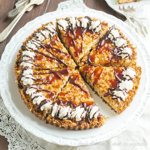 A slice of pie with chocolate sauce on it.