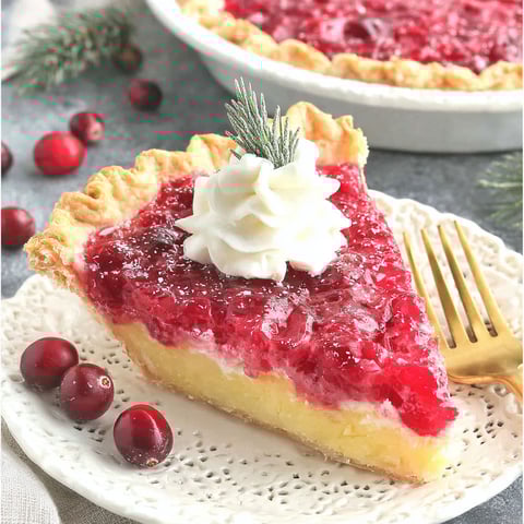 A slice of pie with whipped cream on top.