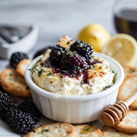 A bowl of food with a lemon wedge on top.