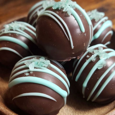 A bowl of chocolate and mint truffles.