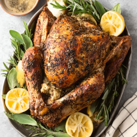 A roasted chicken with lemon and herbs.