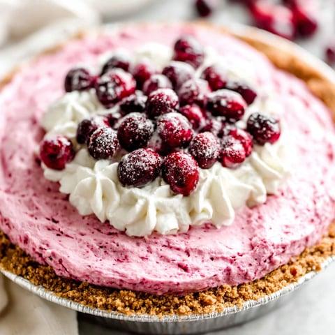 A pie with a cherry topping.