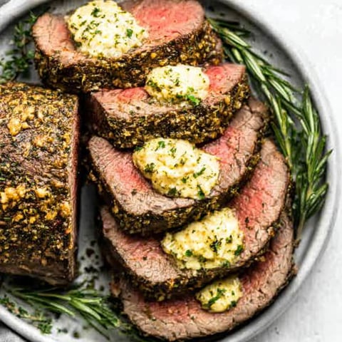 A plate of meat with sauce on it.