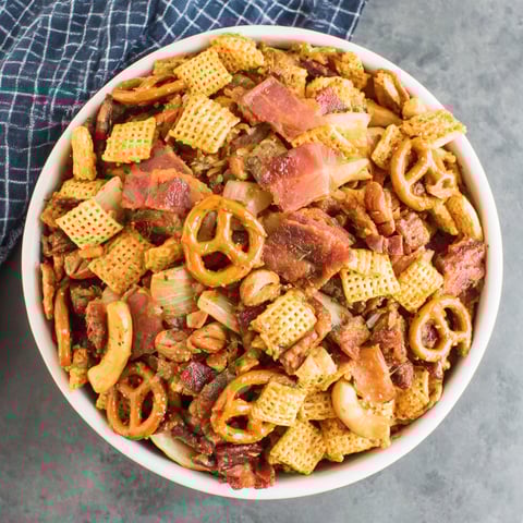 A bowl of bacon and cheese covered chips.