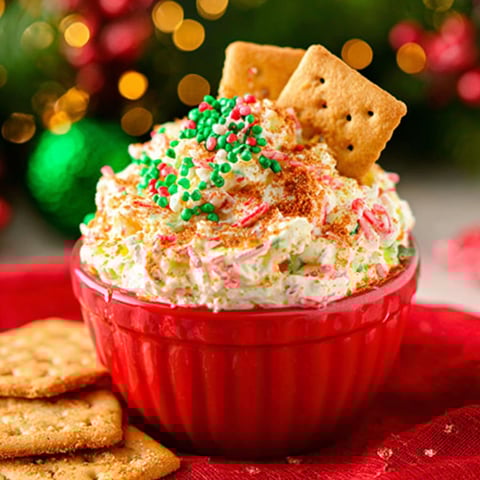 A red bowl filled with a creamy dessert.