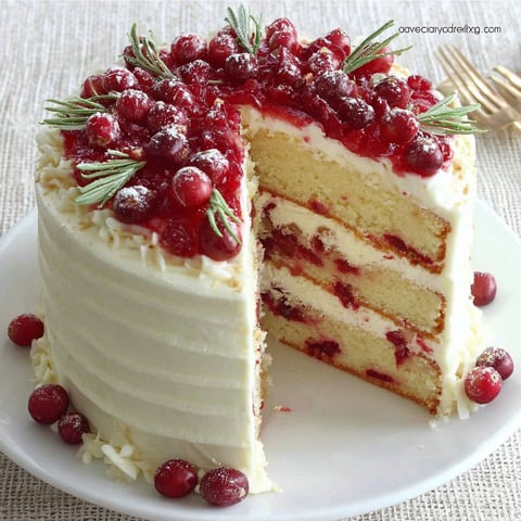 A slice of cake with berries on top.