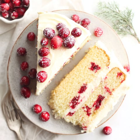 A slice of cake with berries on top.