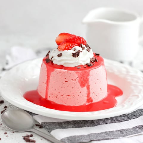 A dessert with strawberries and whipped cream on top.