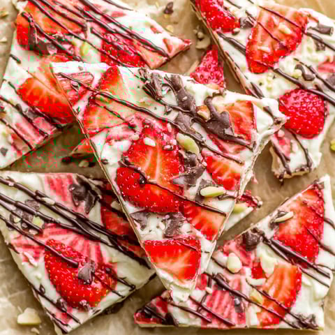 A close up of a strawberry dessert with chocolate drizzle.