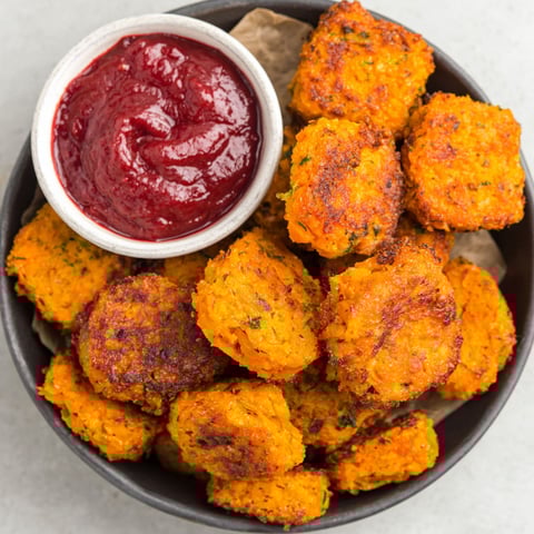 A bowl of food with a sauce on the side.