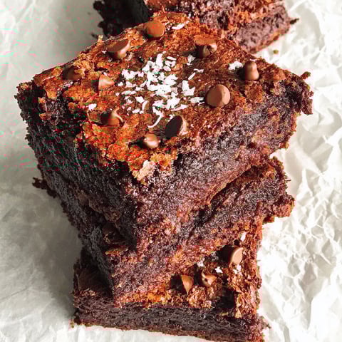 A close up of a chocolate brownie with chocolate chips.