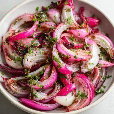 A bowl of food with onions and other vegetables.